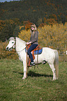 woman rides pony