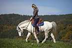 woman rides pony