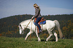 woman rides pony