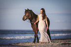 woman leads horse