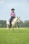 woman rides Quarter Horse