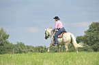 woman rides Quarter Horse