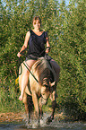 woman rides Quarter Horse