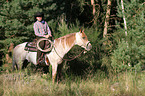 man rides Quarter Horse
