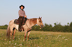 man rides Quarter Horse