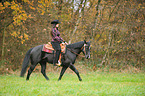 woman rides Quarter Horse