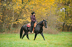 woman rides Quarter Horse