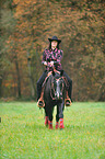 woman rides Quarter Horse
