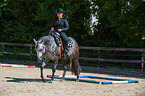 woman rides Quarter Horse