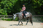 woman rides Quarter Horse