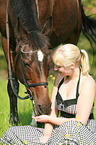 woman feeds Thuringian warmblood