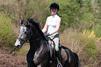 woman rides Trakehner