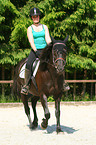 woman rides warmblood