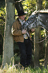 man and Appaloosa-Mix