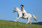 woman rides white horse