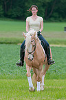 woman rides warmblood