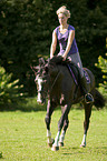 woman rides warmblood
