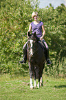 woman rides warmblood