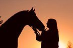 horse and woman in sundown