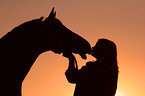 horse and woman in sundown