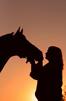 horse and woman in sundown