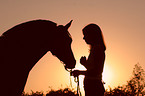 woman with horse in sundown