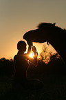 woman with Shetland Pony in sunset light