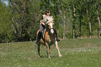 woman rides Haflinger horse