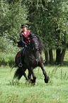 woman with friesian horse at show
