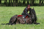 woman with friesian horse at show