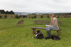 woman with dogs an roe deer
